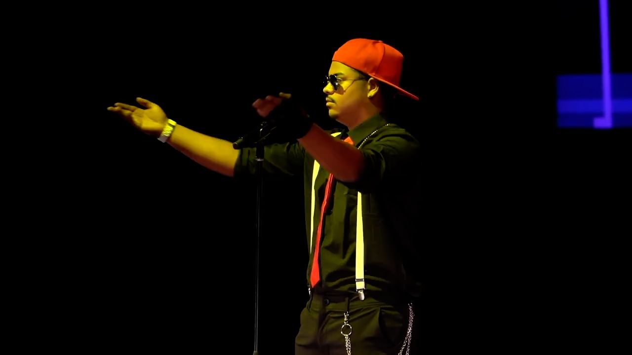 Chuck Wilmore on stage in an orange cap